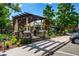 Outdoor restaurant patio with pergola, lush landscaping, and inviting ambiance for outdoor dining at 7000 E Quincy Ave # 204, Denver, CO 80237