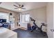 Bright bonus room featuring a Peloton bike, built-in bookcase, and a contemporary ceiling fan with lighting at 1201 Balsam Ave # 203, Boulder, CO 80304