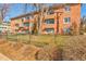 Apartment building shows the fenced-in lawn on a sunny day at 1201 Balsam Ave # 203, Boulder, CO 80304