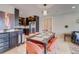 Contemporary kitchen with stainless steel appliances, sleek dark cabinets, and hardwood floors adjacent to dining area at 1201 Balsam Ave # 203, Boulder, CO 80304