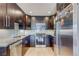Well-equipped kitchen with stainless steel appliances, dark cabinets, a tile backsplash, and hardwood floors at 1201 Balsam Ave # 203, Boulder, CO 80304