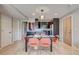 Modern kitchen and dining area with stainless steel appliances, dark cabinets, and a stylish light fixture at 1201 Balsam Ave # 203, Boulder, CO 80304