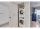 Efficient laundry closet featuring a stacked washer and dryer unit, optimizing space in the home at 1201 Balsam Ave # 203, Boulder, CO 80304