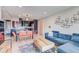 Stylish living room featuring hardwood floors, a comfortable blue sofa, and an open-concept layout with a dining area at 1201 Balsam Ave # 203, Boulder, CO 80304
