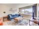 Bright living room with hardwood floors, a comfortable blue sofa, and large windows offering city views at 1201 Balsam Ave # 203, Boulder, CO 80304