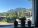 Window view of lush trees, mountain peaks, and city streets creating a serene and vibrant scene at 1201 Balsam Ave # 203, Boulder, CO 80304
