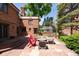 Brick house backyard with a patio area with seating and a greenhouse at 100 N Gaylord St, Denver, CO 80206