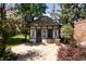 Backyard studio with gray and white Tudor design on a paved area with barrel accents at 100 N Gaylord St, Denver, CO 80206