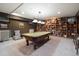 Finished basement featuring a pool table, built-in bookshelves, and neutral carpet at 100 N Gaylord St, Denver, CO 80206