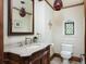 Elegant powder room featuring a marble vanity, ornate wood cabinet, and decorative lighting at 100 N Gaylord St, Denver, CO 80206