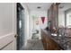 Bathroom featuring stone tiled floor, shower and vanity with granite countertop at 100 N Gaylord St, Denver, CO 80206