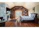 Spacious bedroom featuring a stone fireplace, wooden floors and an expansive built-in bookcase at 100 N Gaylord St, Denver, CO 80206