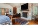 Another view of the bedroom showcases a fireplace and additional built-in bookcase at 100 N Gaylord St, Denver, CO 80206