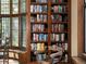 Close-up of living room shelves with a rolling library ladder and light streaming in through the window at 100 N Gaylord St, Denver, CO 80206