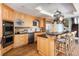 Modern kitchen featuring maple cabinetry, black countertops, and stainless steel appliances at 100 N Gaylord St, Denver, CO 80206