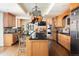 Gourmet kitchen with stainless steel appliances, black countertops, and center island at 100 N Gaylord St, Denver, CO 80206