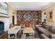 Spacious living room with custom wood bookshelves, a fireplace, and hardwood floors at 100 N Gaylord St, Denver, CO 80206