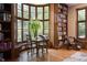 Sun-drenched room with custom bookcases, a bay window, and hardwood flooring at 100 N Gaylord St, Denver, CO 80206