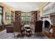 Elegant living room featuring built-in bookshelves, hardwood floors, and a classic stone fireplace at 100 N Gaylord St, Denver, CO 80206