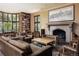 Inviting living room with a stone fireplace, bay windows, hardwood floors, and built-in bookshelves at 100 N Gaylord St, Denver, CO 80206