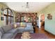 Open-concept living room with bookshelves, large arch window, and comfortable seating at 100 N Gaylord St, Denver, CO 80206