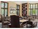 Cozy living room with a fireplace, large bay windows, and custom bookshelves with lots of sunlight at 100 N Gaylord St, Denver, CO 80206