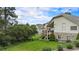 Sprawling backyard featuring a grassy lawn, wooden deck, and mature trees at 1405 Castlepoint Circle, Castle Pines, CO 80108