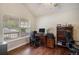 Well-lit bedroom featuring hardwood floors, a ceiling fan, and a bright window at 1405 Castlepoint Circle, Castle Pines, CO 80108