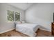 Minimalist bedroom with bright window and hardwood floors at 1405 Castlepoint Circle, Castle Pines, CO 80108