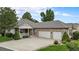 Inviting home exterior features a cozy front porch and a convenient three-car garage at 1405 Castlepoint Circle, Castle Pines, CO 80108