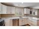 Bright kitchen features white cabinets, stainless steel appliances, and plenty of countertop space at 1405 Castlepoint Circle, Castle Pines, CO 80108