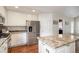 Spacious kitchen featuring stainless steel refrigerator and stone countertops on island at 1405 Castlepoint Circle, Castle Pines, CO 80108