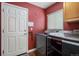 Laundry room with modern washer and dryer, hooks for keys, and ample space at 1405 Castlepoint Circle, Castle Pines, CO 80108