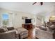 Inviting living room with hardwood floors, comfortable seating, and a large entertainment center at 1405 Castlepoint Circle, Castle Pines, CO 80108