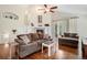 Comfortable living room with hardwood floors, a fireplace, and sliding glass doors to the patio at 1405 Castlepoint Circle, Castle Pines, CO 80108