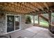 Covered outdoor patio area made of stone with stairs leading to the grassy lawn at 1405 Castlepoint Circle, Castle Pines, CO 80108