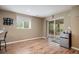 Open room featuring wood floors, a sliding glass door to the outdoor patio, and a mini fridge at 1405 Castlepoint Circle, Castle Pines, CO 80108