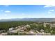 Picturesque aerial view of homes surrounded by lush green landscape and distant mountains at 1734 Summerglow Ln, Monument, CO 80132