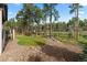 Beautiful backyard with a rock bed, lawn, and mature trees providing a peaceful outdoor space at 1734 Summerglow Ln, Monument, CO 80132