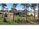 Serene backyard featuring a fire pit area, lush lawn, and lovely landscaping at 1734 Summerglow Ln, Monument, CO 80132