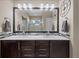 Spacious bathroom featuring a double vanity with a large mirror and modern lighting fixtures at 1734 Summerglow Ln, Monument, CO 80132