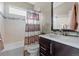 Well-lit bathroom with a tiled bathtub, stylish vanity, and modern fixtures, and decorative touches at 1734 Summerglow Ln, Monument, CO 80132