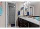 Modern bathroom features decorative mirror, stylish vanity, and tiled shower with sleek design at 1734 Summerglow Ln, Monument, CO 80132