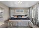 Comfortable bedroom featuring a large bed, soft carpet, and ample natural light at 1734 Summerglow Ln, Monument, CO 80132