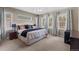 Spacious bedroom with large windows, neutral carpet, and elegant decor at 1734 Summerglow Ln, Monument, CO 80132