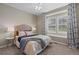 Cozy bedroom with a large window, natural light, and stylish decor with a ceiling fan at 1734 Summerglow Ln, Monument, CO 80132