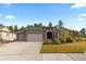 Inviting single-story home with a three-car garage and landscaped front yard at 1734 Summerglow Ln, Monument, CO 80132
