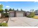 Attached three-car garage with large concrete driveway and meticulously maintained landscaping at 1734 Summerglow Ln, Monument, CO 80132