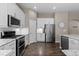 Well-equipped kitchen featuring stainless steel appliances, ample white cabinetry, and granite countertops at 1734 Summerglow Ln, Monument, CO 80132