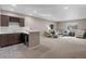 Open-concept living room boasts a wet bar, modern furniture, and ample space for entertaining at 1734 Summerglow Ln, Monument, CO 80132